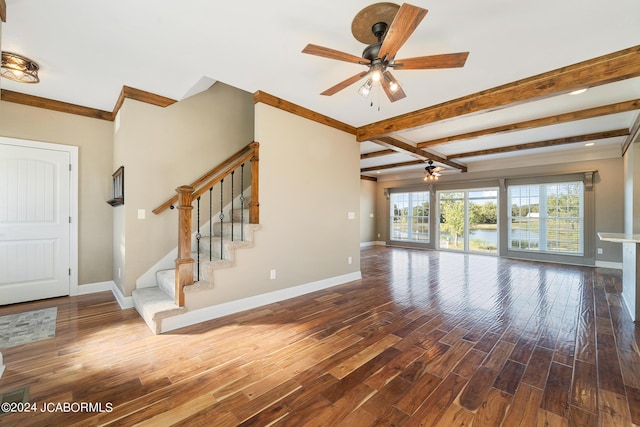 unfurnished living room featuring ceiling fan, dark hardwood / wood-style flooring, and beamed ceiling