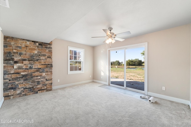 spare room with light colored carpet and ceiling fan