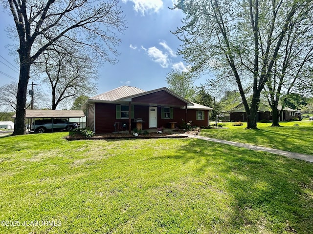 view of front of home featuring a porch, a carport, a front yard, and metal roof