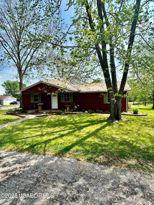 ranch-style home with covered porch and a front yard