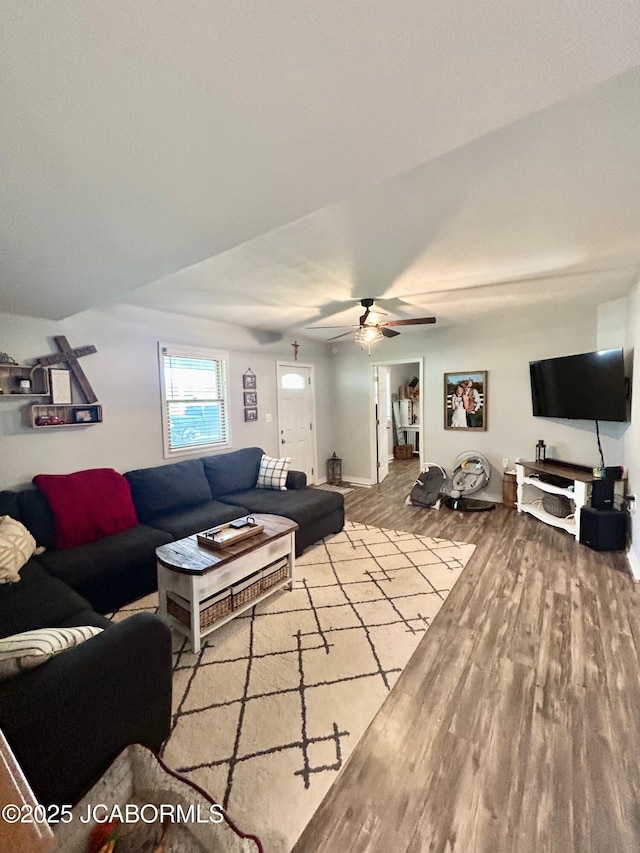 living area with ceiling fan, wood finished floors, and baseboards
