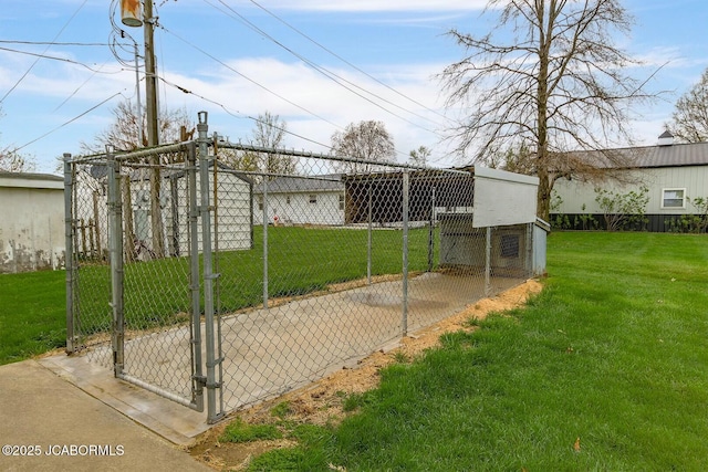 view of gate featuring a yard and an outdoor structure