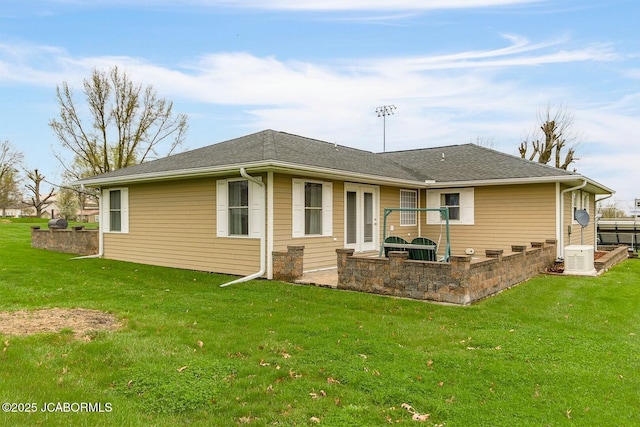rear view of house featuring a patio and a lawn