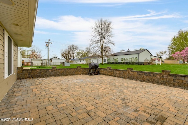 view of patio / terrace with a grill and a residential view