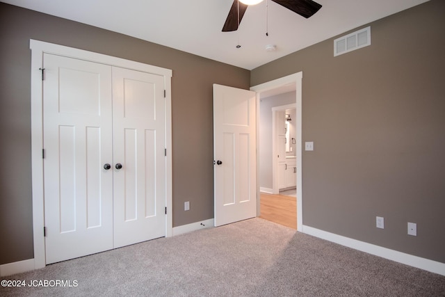 unfurnished bedroom featuring visible vents, ceiling fan, baseboards, carpet, and a closet