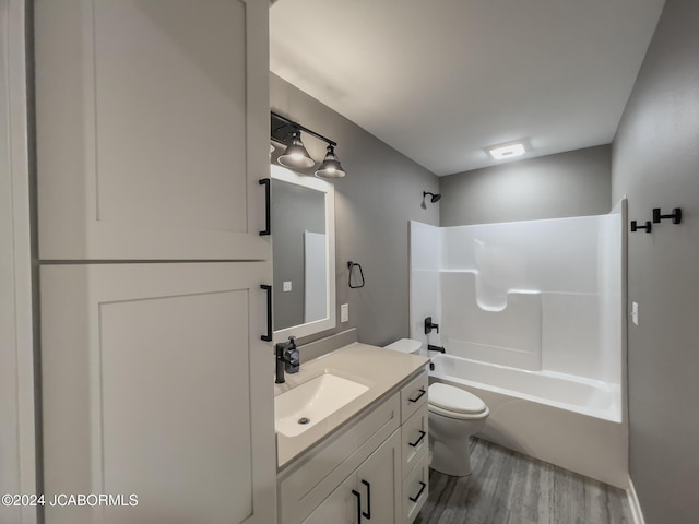 full bathroom featuring shower / washtub combination, toilet, vanity, and wood finished floors