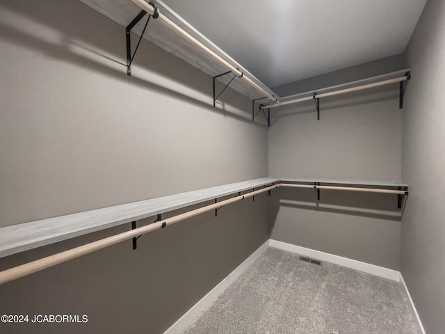 spacious closet with visible vents and carpet floors