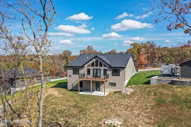 back of house featuring a wooden deck, a yard, a patio area, and a shingled roof