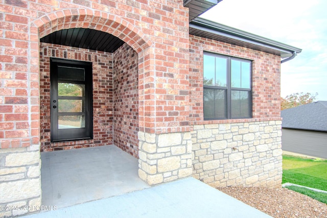 property entrance featuring brick siding