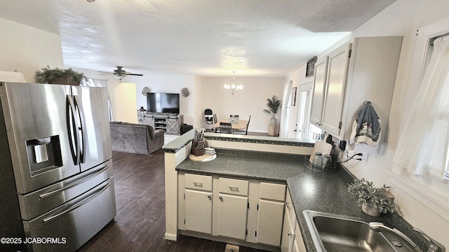 kitchen featuring sink, dark hardwood / wood-style floors, a textured ceiling, stainless steel fridge with ice dispenser, and ceiling fan with notable chandelier