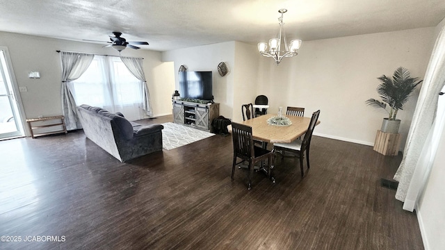 dining space with dark hardwood / wood-style floors and ceiling fan with notable chandelier