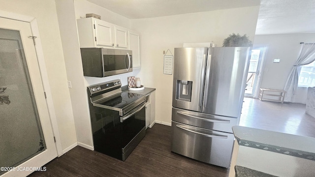 kitchen featuring white cabinetry, dark wood-type flooring, and stainless steel appliances