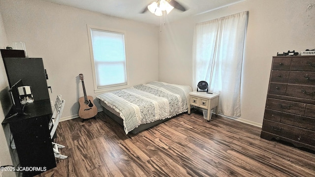 bedroom with ceiling fan and dark hardwood / wood-style flooring