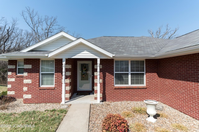 doorway to property with brick siding