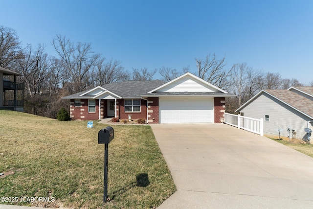 single story home with a front lawn, brick siding, a garage, and driveway