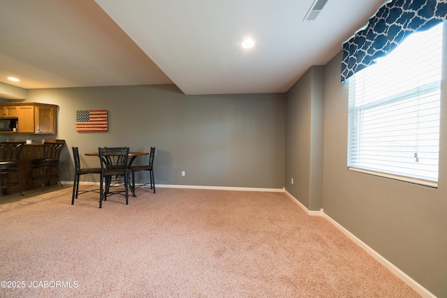 dining space with recessed lighting, baseboards, light carpet, and visible vents