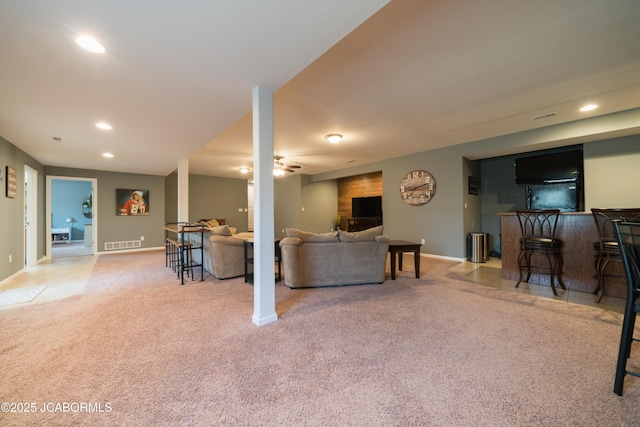 carpeted living room featuring visible vents, recessed lighting, a bar, baseboards, and ceiling fan