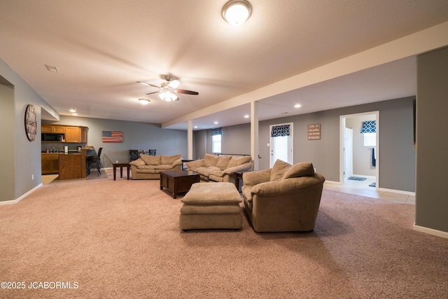 living room featuring recessed lighting, indoor wet bar, baseboards, light colored carpet, and ceiling fan