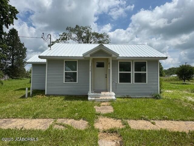 210 Academy St, Clarksburg, MO 65025 - bungalow-style home with a front yard and a metal roof