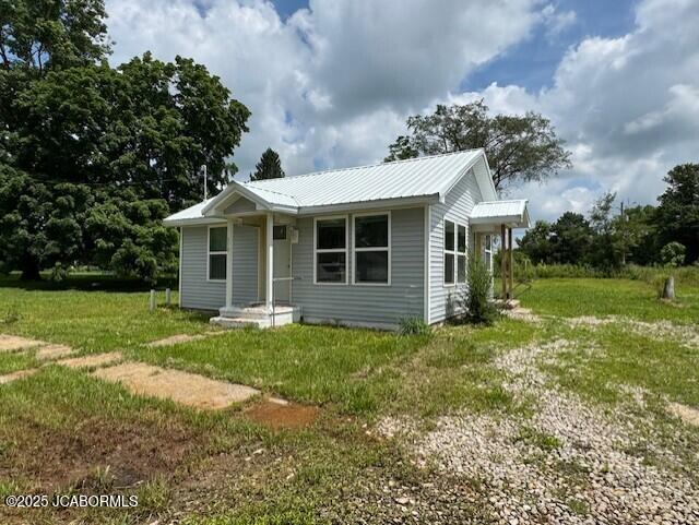 210 Academy St, Clarksburg, MO 65025 - view of front of property with a front yard and a metal roof