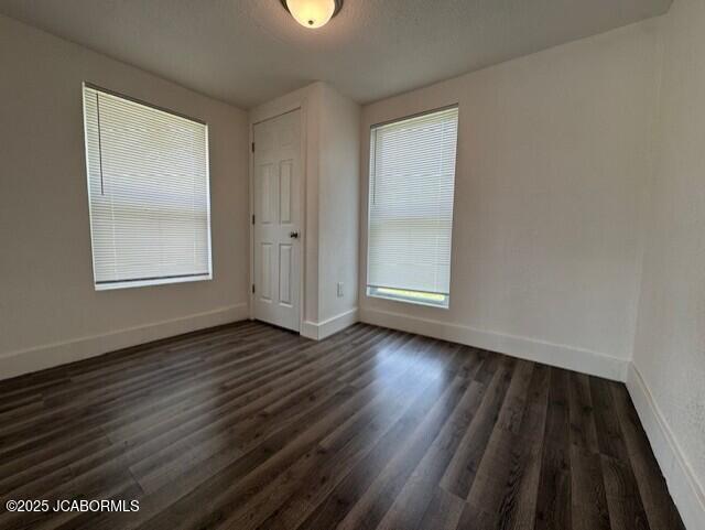 210 Academy St, Clarksburg, MO 65025 - empty room featuring dark wood-style floors and baseboards