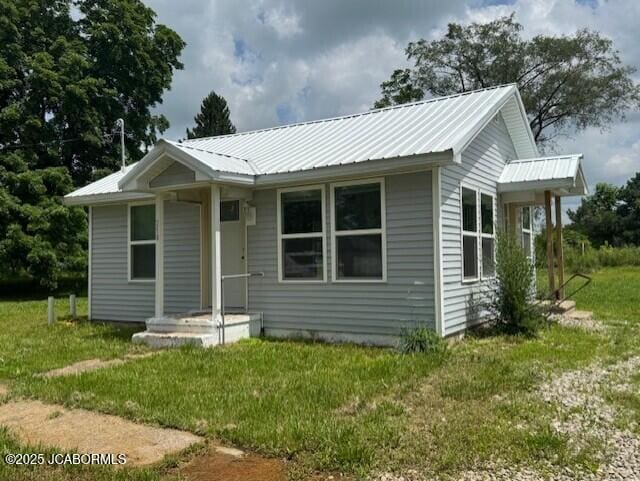 210 Academy St, Clarksburg, MO 65025 - view of front of property with a front lawn and a metal roof
