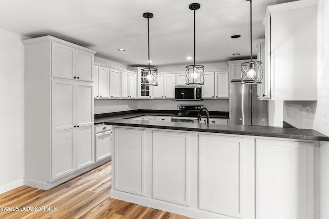 600 Peterson Ln, Ashland, MO 65010 - kitchen with appliances with stainless steel finishes, light wood-style flooring, white cabinetry, a peninsula, and recessed lighting