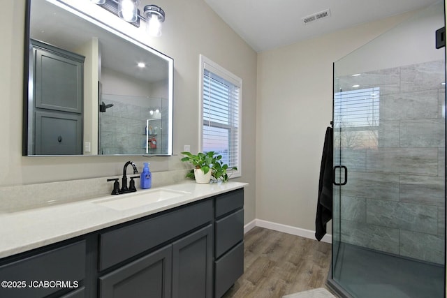 bathroom featuring vanity, hardwood / wood-style floors, and walk in shower