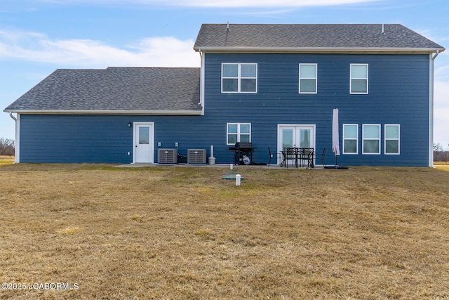 rear view of house featuring a yard, central AC unit, and a patio