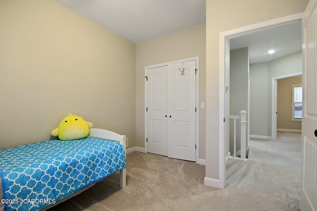 bedroom with light colored carpet and a closet