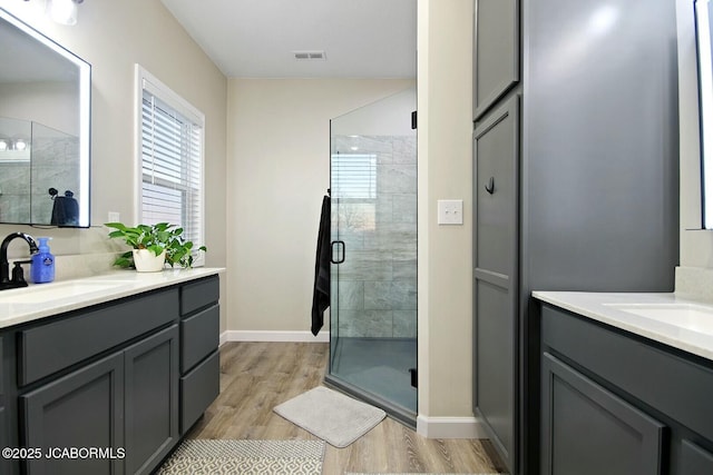 bathroom featuring vanity, hardwood / wood-style floors, and an enclosed shower