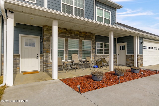 entrance to property with a garage and covered porch