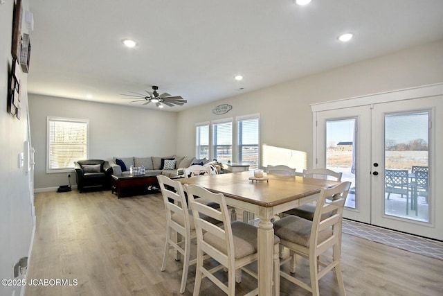 dining area with french doors, ceiling fan, and light wood-type flooring