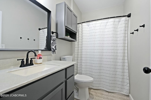 bathroom with vanity, a shower with shower curtain, and toilet