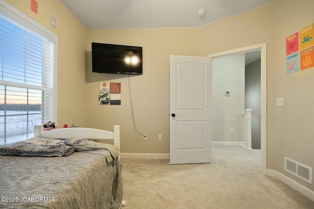 bedroom featuring light carpet