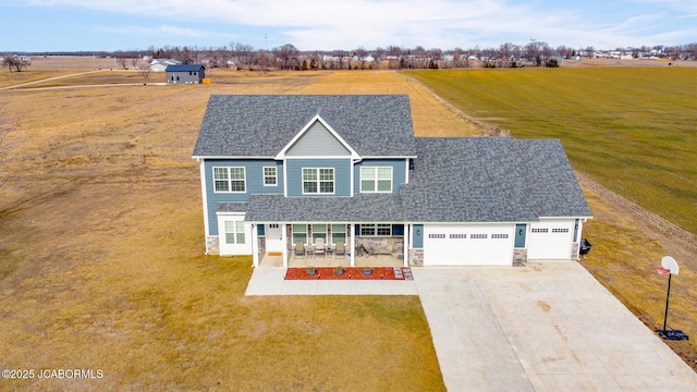 view of front of property with a rural view, covered porch, and a front lawn