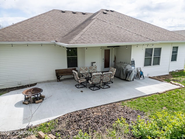 2414 Camzie Dr, Jefferson City, MO 65101 - rear view of house with a patio area, roof with shingles, and an outdoor fire pit