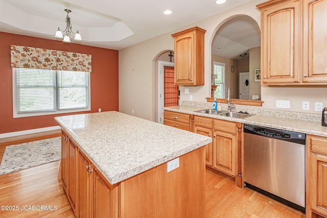 2414 Camzie Dr, Jefferson City, MO 65101 - kitchen with arched walkways, a kitchen island, dishwasher, a sink, and light wood finished floors