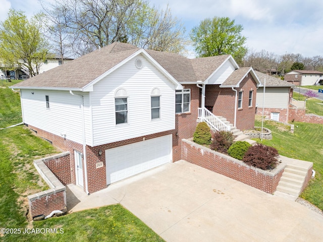 2414 Camzie Dr, Jefferson City, MO 65101 - single story home with an attached garage, driveway, a front lawn, and brick siding
