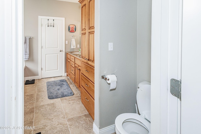 2414 Camzie Dr, Jefferson City, MO 65101 - bathroom with toilet, baseboards, and vanity