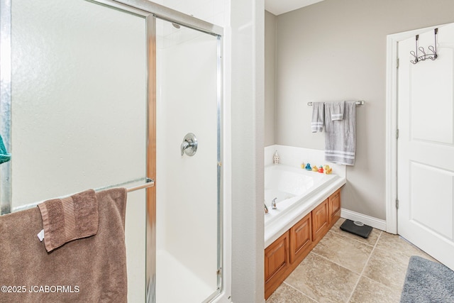 2414 Camzie Dr, Jefferson City, MO 65101 - full bath with a shower stall, a garden tub, and baseboards
