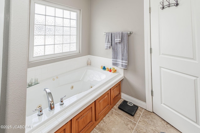 2414 Camzie Dr, Jefferson City, MO 65101 - bathroom with tile patterned floors, plenty of natural light, a jetted tub, and baseboards