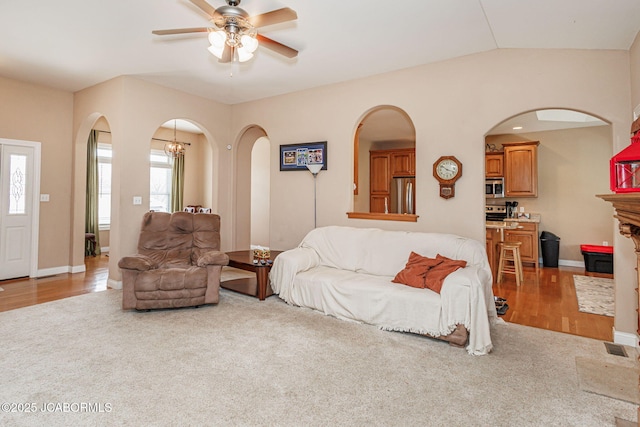 2414 Camzie Dr, Jefferson City, MO 65101 - carpeted living room featuring a wealth of natural light, arched walkways, ceiling fan, and baseboards