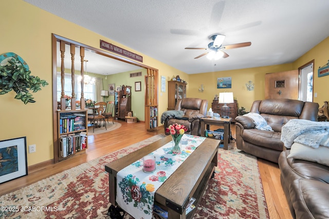 409 Lorene St, California, MO 65018 - living room with wood finished floors, ceiling fan, and a chandelier