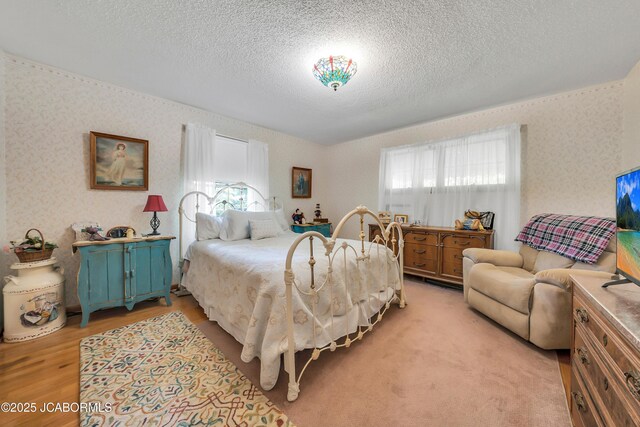 409 Lorene St, California, MO 65018 - bedroom featuring a textured ceiling, light wood-type flooring, and wallpapered walls