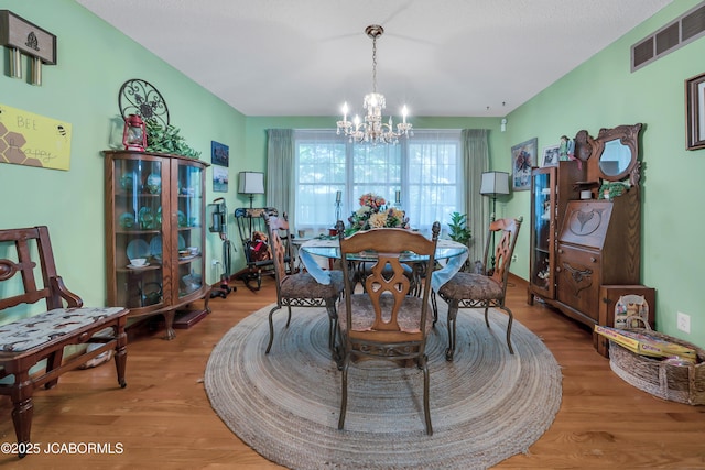 409 Lorene St, California, MO 65018 - dining area with wood finished floors and a chandelier