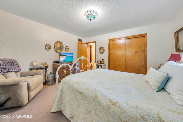 409 Lorene St, California, MO 65018 - carpeted bedroom featuring a closet, a textured ceiling, and wallpapered walls
