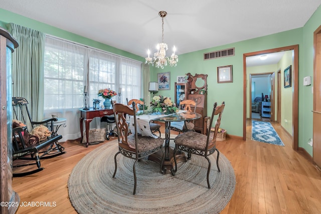 409 Lorene St, California, MO 65018 - dining room with a chandelier and light wood finished floors