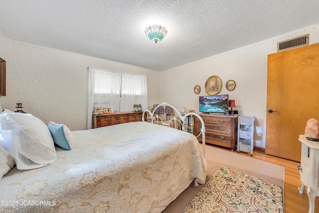 409 Lorene St, California, MO 65018 - bedroom featuring a textured ceiling and light wood-style flooring