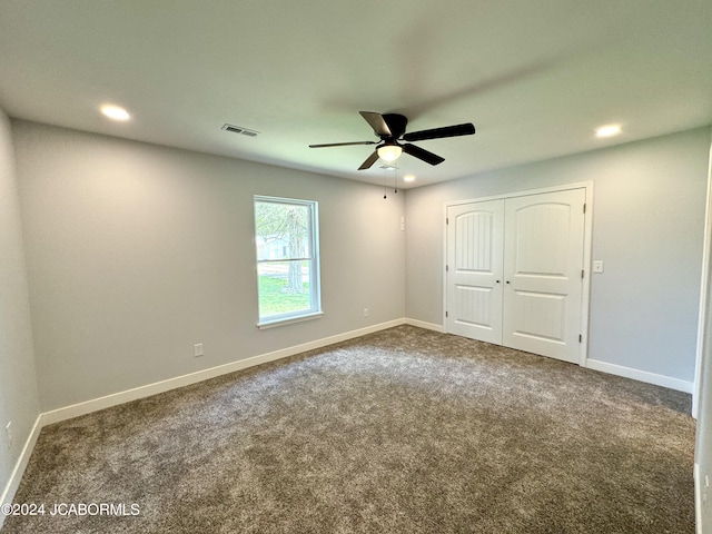 unfurnished bedroom with carpet floors, a closet, and ceiling fan